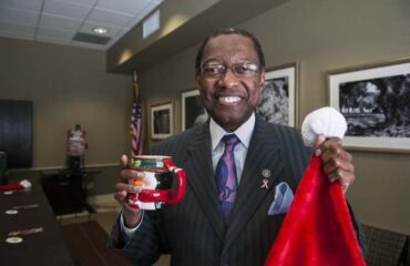 Mayor Melvin Kip Holden Holding a Cup